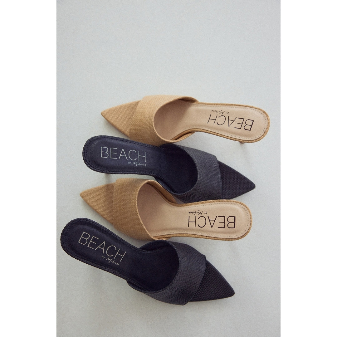 Pair of pointed-toe heeled sandals in black and beige on a light gray background with 'BEACH by Matisse' branding.
