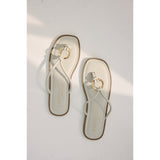 Pair of sandals with a gold ring design and 'Coconuts by Matisse' branding on a light gray background.