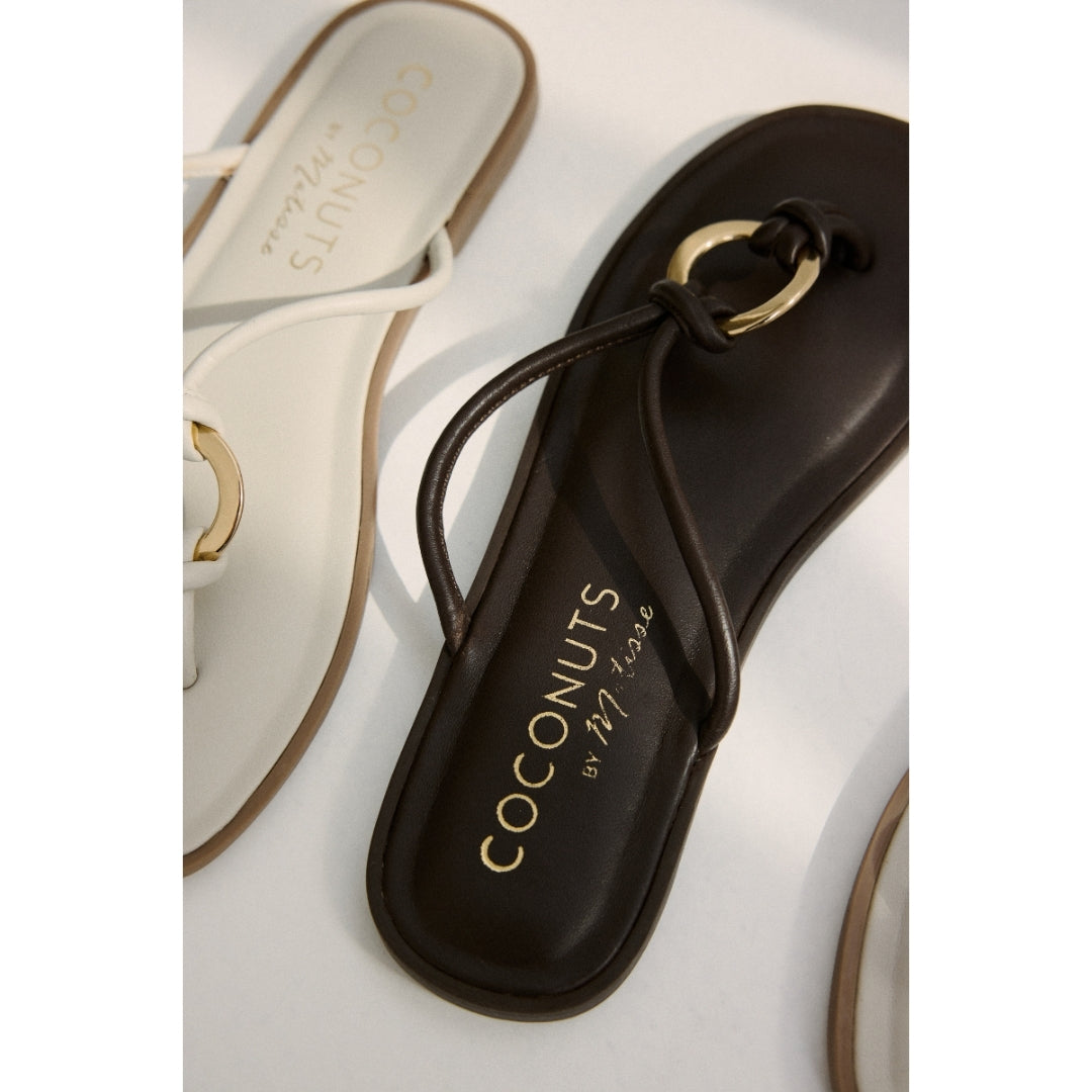 Dark brown and white sandals with 'Coconuts by Matisse' branding on a white background.