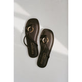 Pair of dark brown sandals with gold accents and 'Coconuts by Matisse' branding on a light gray background.