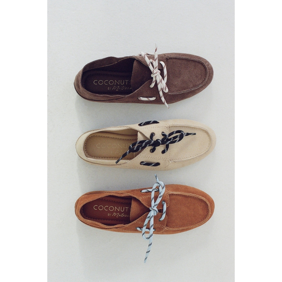Three pairs of brown, tan and beige boat shoes with 'Coconuts by Matisse' branding on a light gray background.