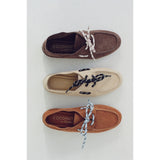 Three pairs of brown, tan and beige boat shoes with 'Coconuts by Matisse' branding on a light gray background.