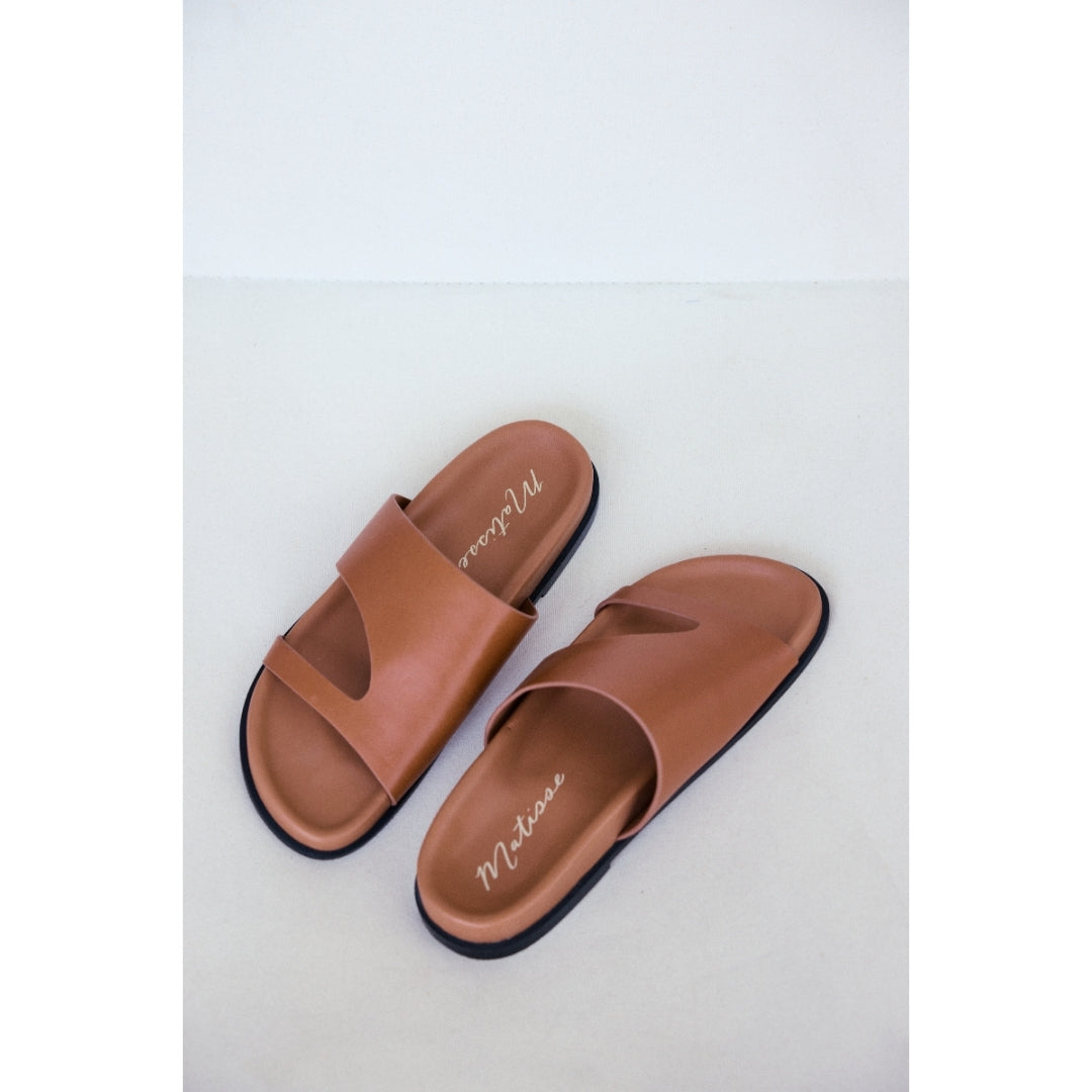 Pair of brown sandals with 'Matisse' branding on a light gray background.