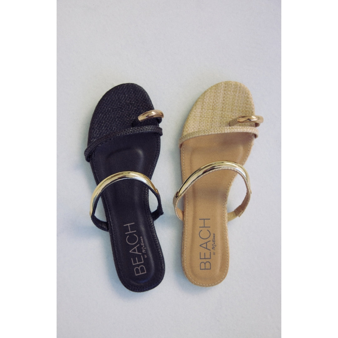 Black and beige sandals with gold straps and 'Beach by Matisse' branding on a light gray background.