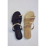 Black and beige sandals with gold straps and 'Beach by Matisse' branding on a light gray background.