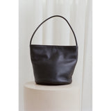 Black leather handbag on a white background.
