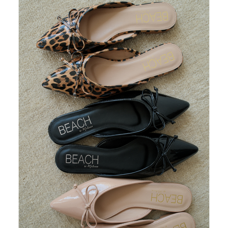 Reggie Vegan Pointed Toe Mule – Beach by Matisse – Faux patent leather leopard print flat mule with pointed toe and petite bow detail.