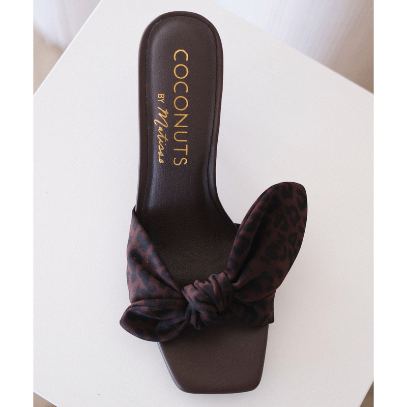 Uptown Vegan Heeled Sandal – Coconuts by Matisse – Brown slip-on sandal with square toe, leopard print bow strap, and tapered kitten heel.