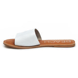A minimalist essential, these white leather slide sandals feature a wide single strap and a flat sole. A versatile slip-on design perfect for effortless everyday wear.