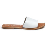 A minimalist essential, these white leather slide sandals feature a wide single strap and a flat sole. A versatile slip-on design perfect for effortless everyday wear.