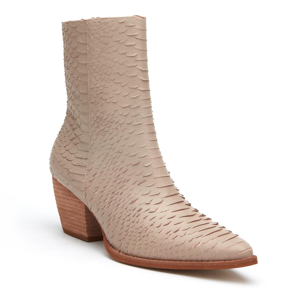 A refined take on western-inspired style, these beige ankle boots feature a pointed toe, textured finish, and stacked block heel. Versatile and effortlessly chic.