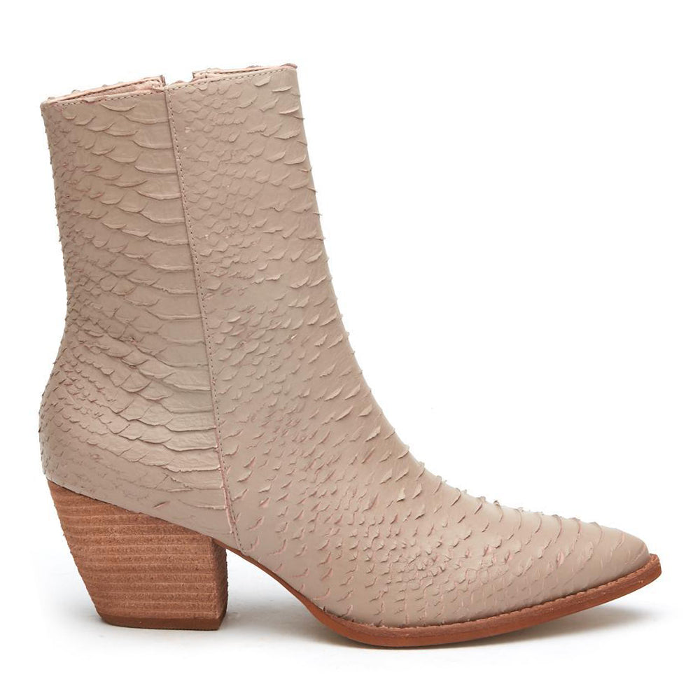 A refined take on western-inspired style, these beige ankle boots feature a pointed toe, textured finish, and stacked block heel. Versatile and effortlessly chic.